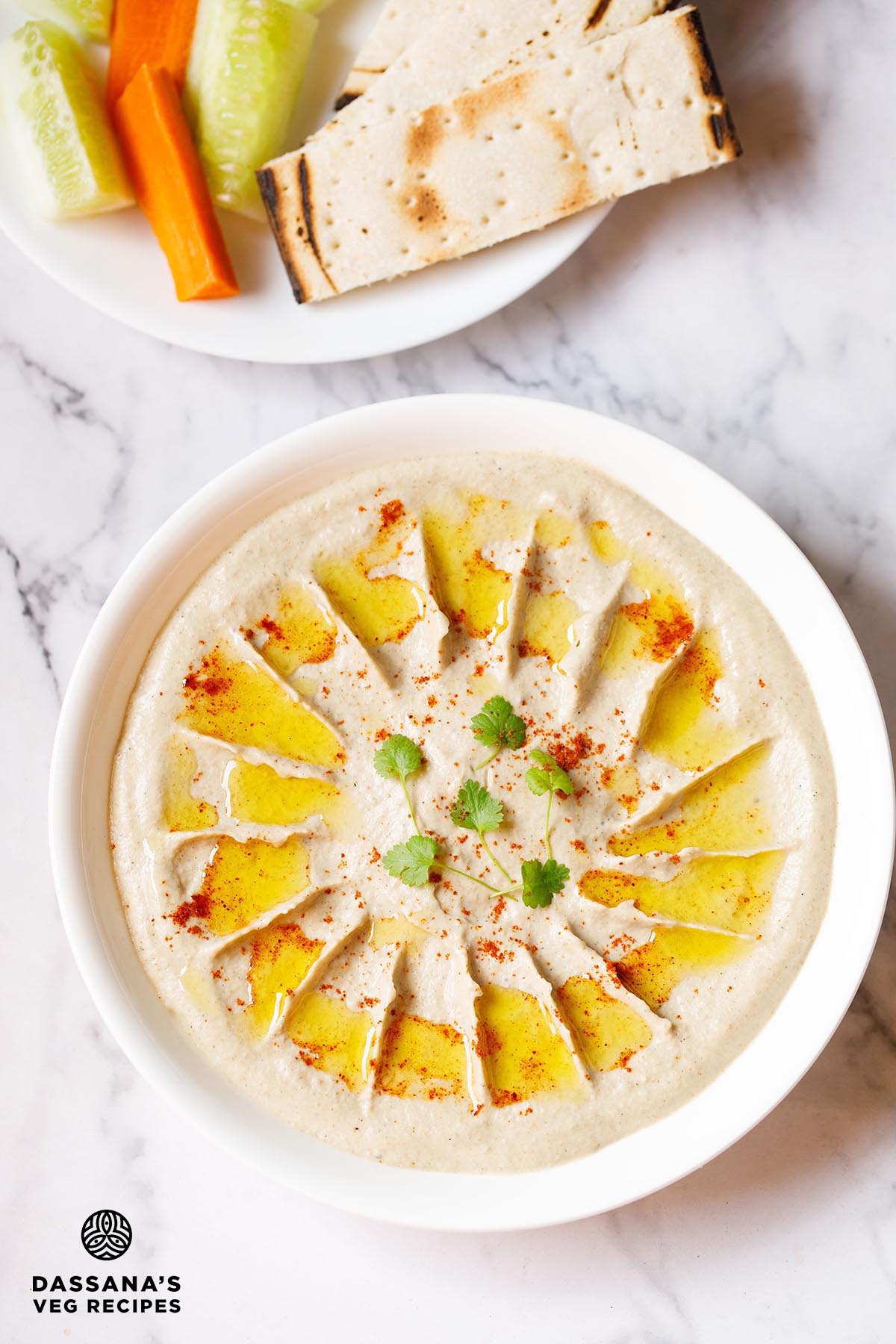 Creamy baba ganoush with olive oil drizzle in bowl.