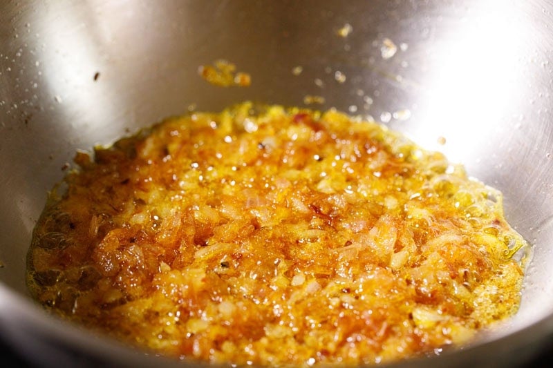 Sautéed golden brown onions in pan.