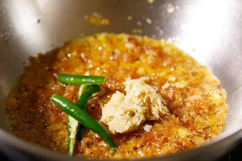Slit green chilies and ginger garlic paste in pan.