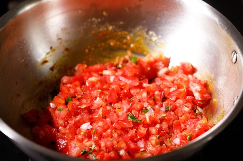 Chopped tomatoes in pan.