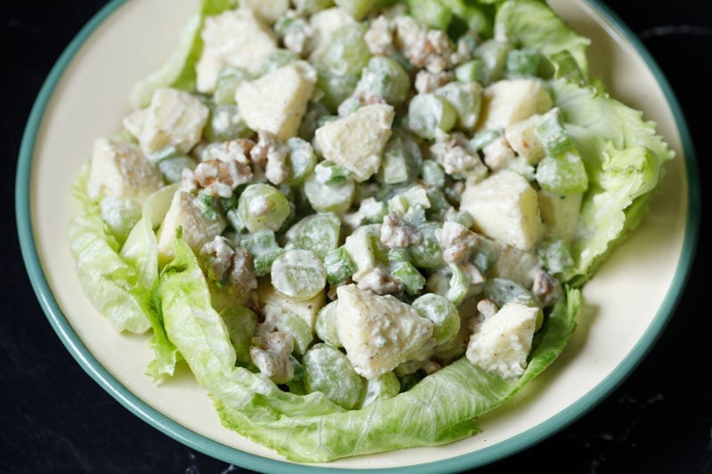 Creamy waldorf salad on lettuce.