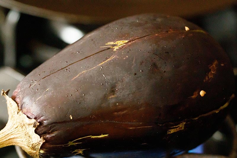 Eggplant roasting on a stove.