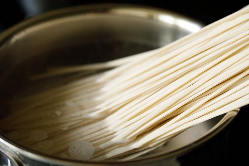 Udon noodles boiling in water.