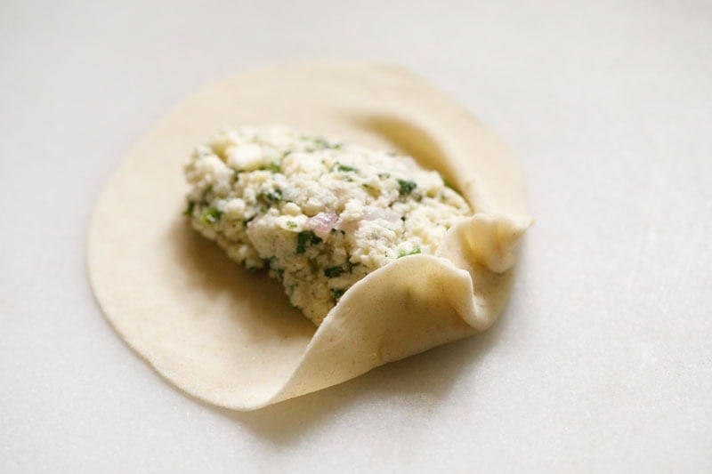 Dough with filling ready for folding.