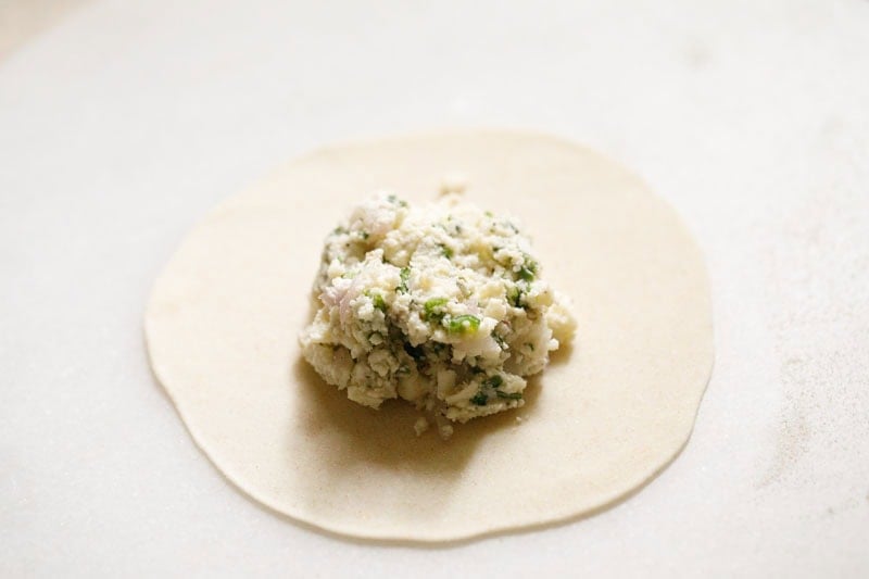 Rolled round dough with paneer filling.