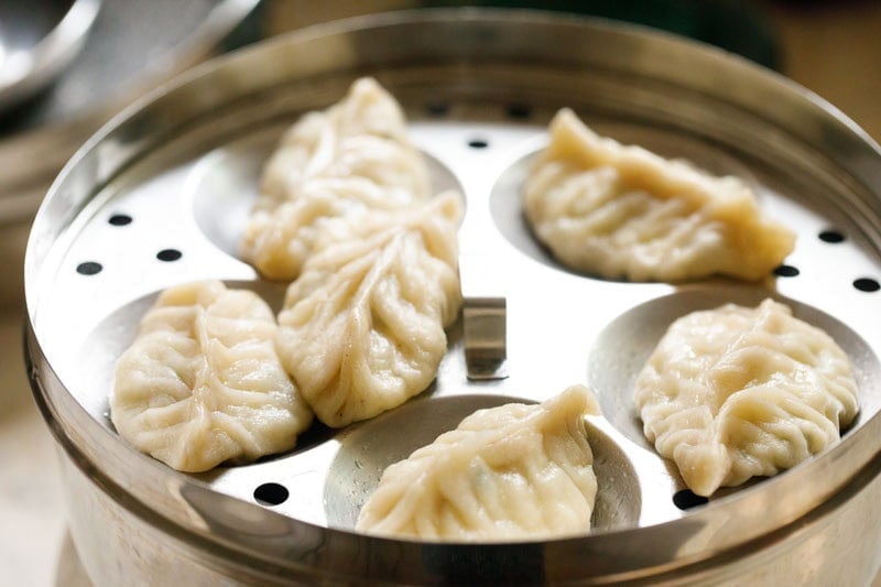 Steamed paneer momos in a steamer.
