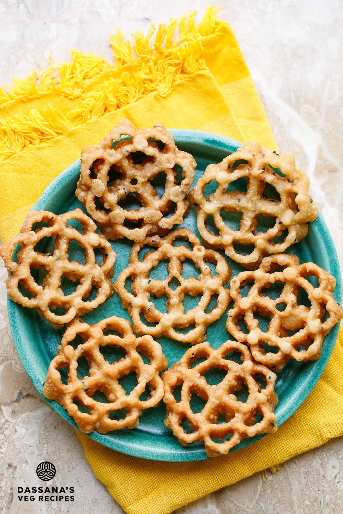 Fried, intricate, floral-shaped rose cookie.