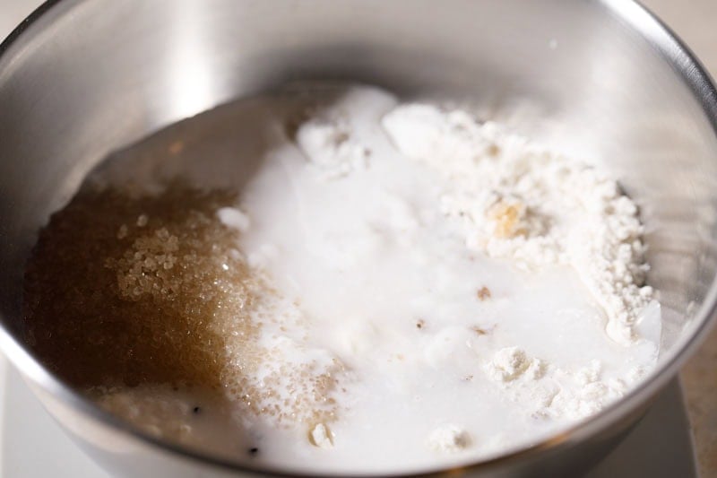 Canned coconut milk in bowl with the flours and sugar.