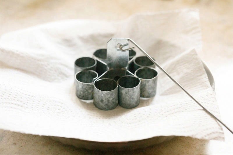 metal rose cookie mould on paper towel.