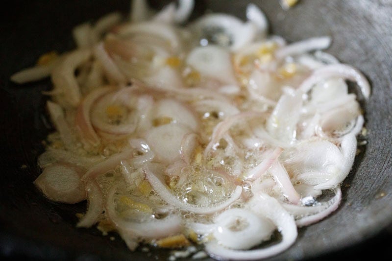 Sautéing sliced onions in oil.