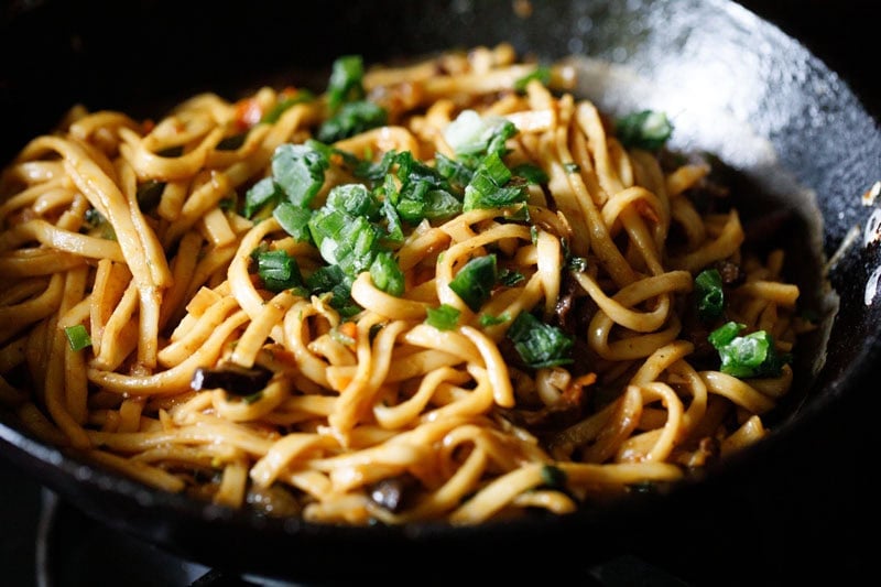 Stir-fried yaki udon noodles with green onions.