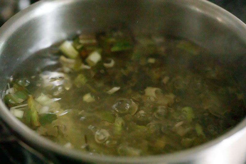 water boiling with lemongrass stalks.