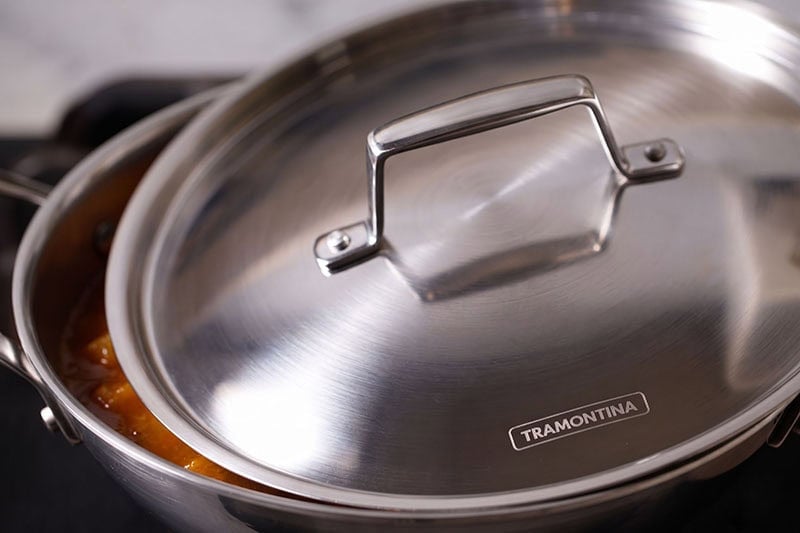 Stainless steel lid covered on the pan.