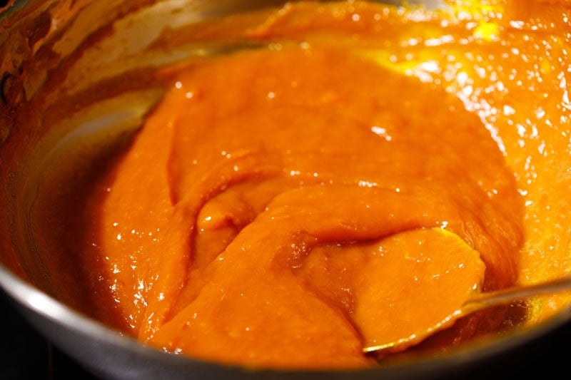 Thick mango jam in pan.