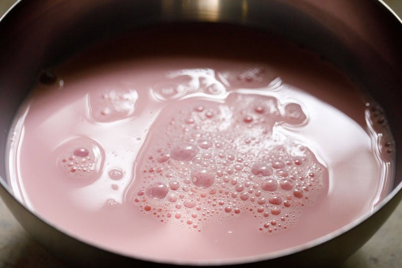 pink colored milk in bowl.