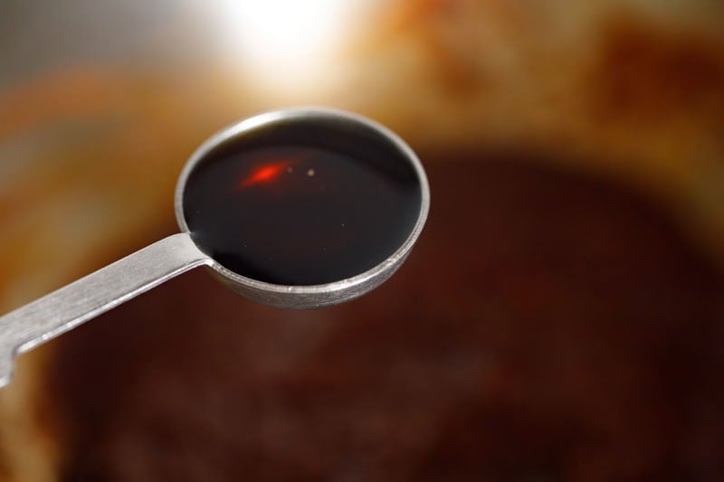 red wine vinegar in a measuring spoon.