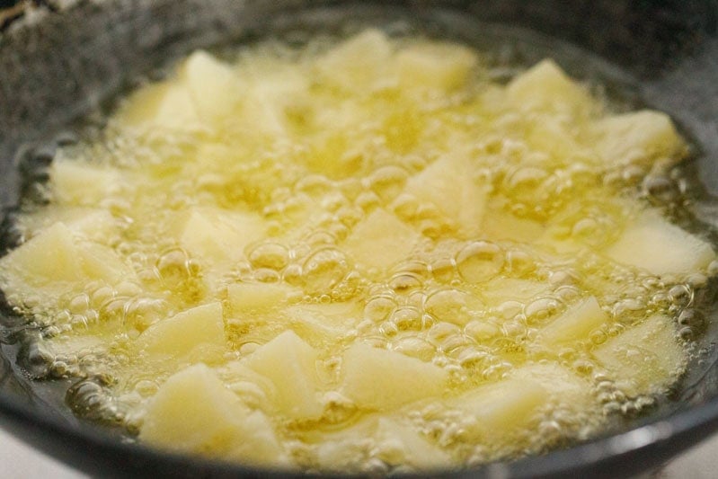 potatoes frying in oil.