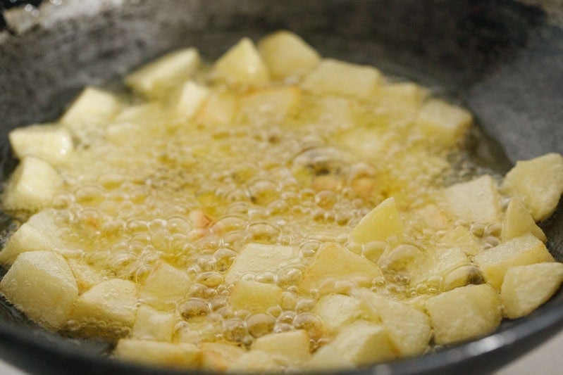 potatoes frying in hot oil.