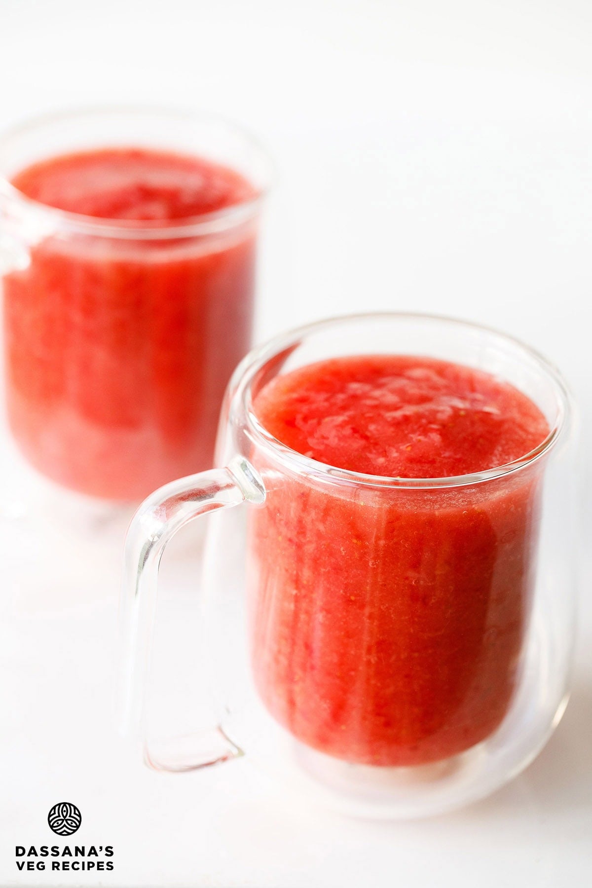 Two glasses of strawberry juice.