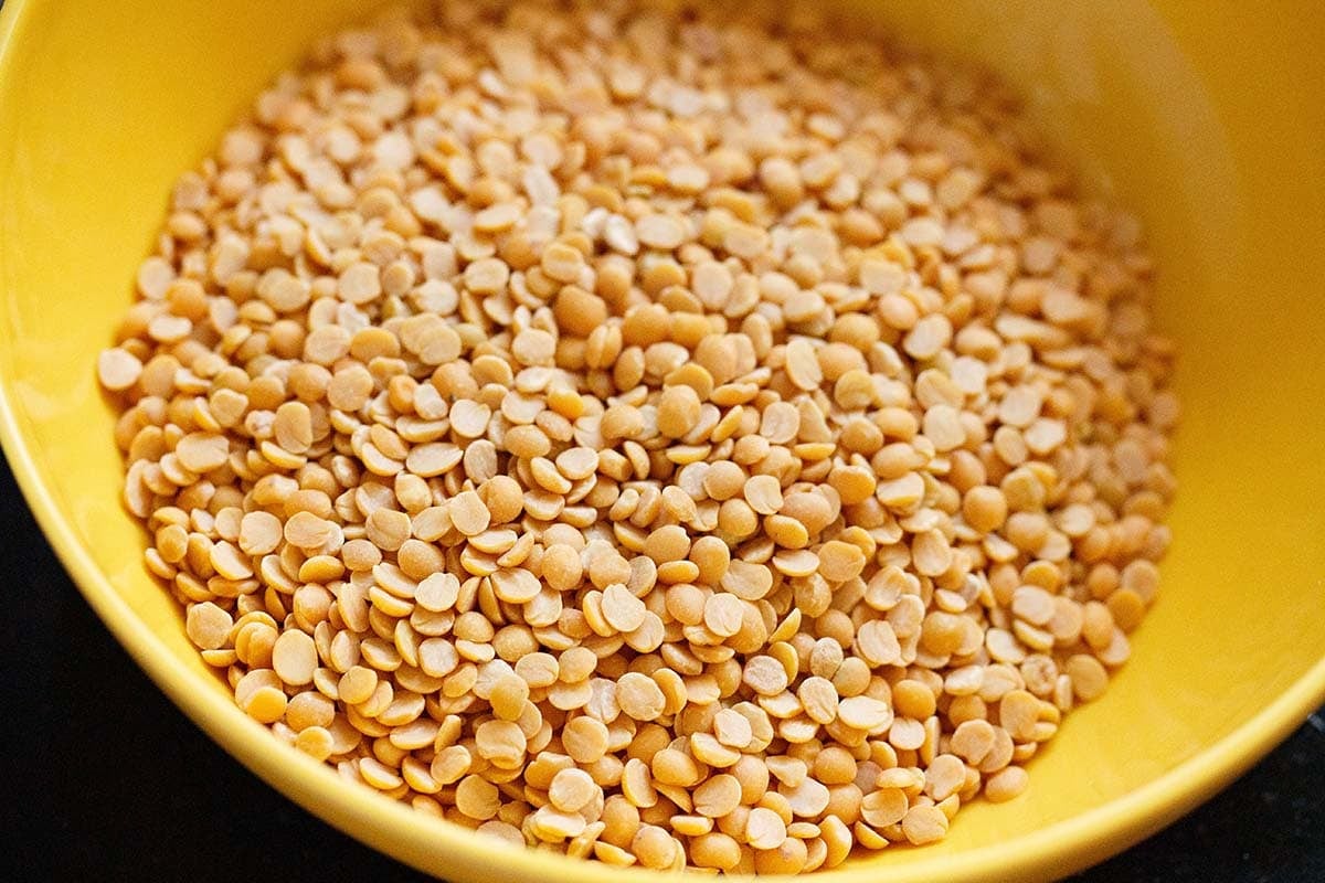 Hulled and split toor dal also called arhar dal or pigeon pea lentils in a bowl.