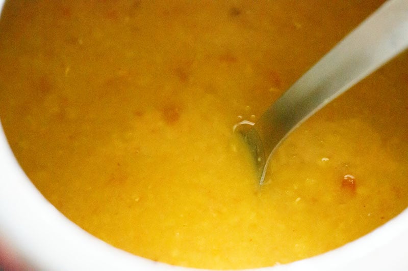 Yellow tur dal with spoon.