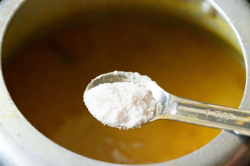 Spoonful of salt above cooker.