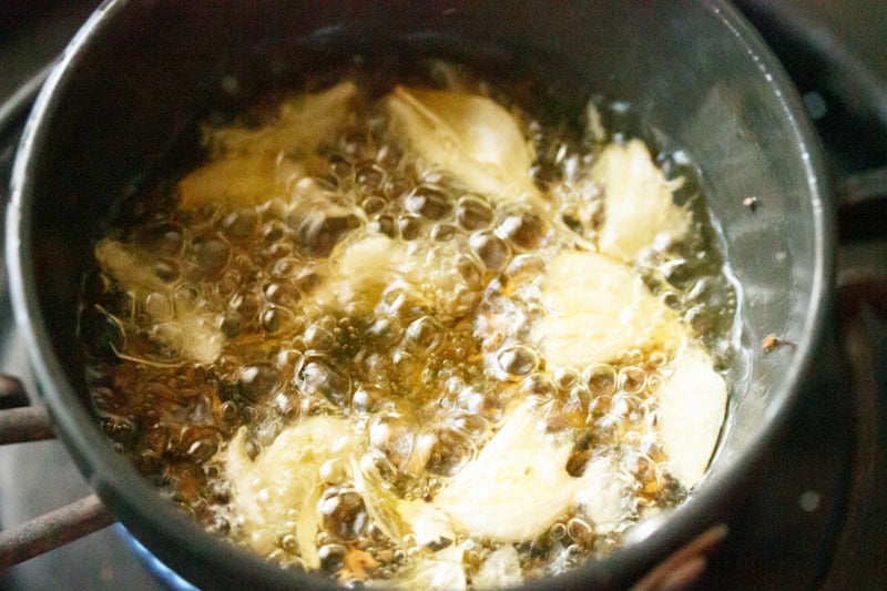 Garlic being fried in oil.