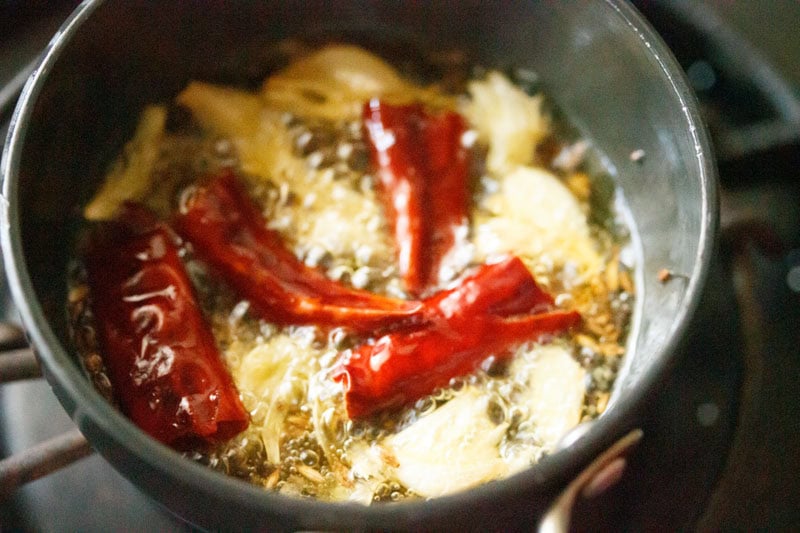 Frying red chilies in hot oil.