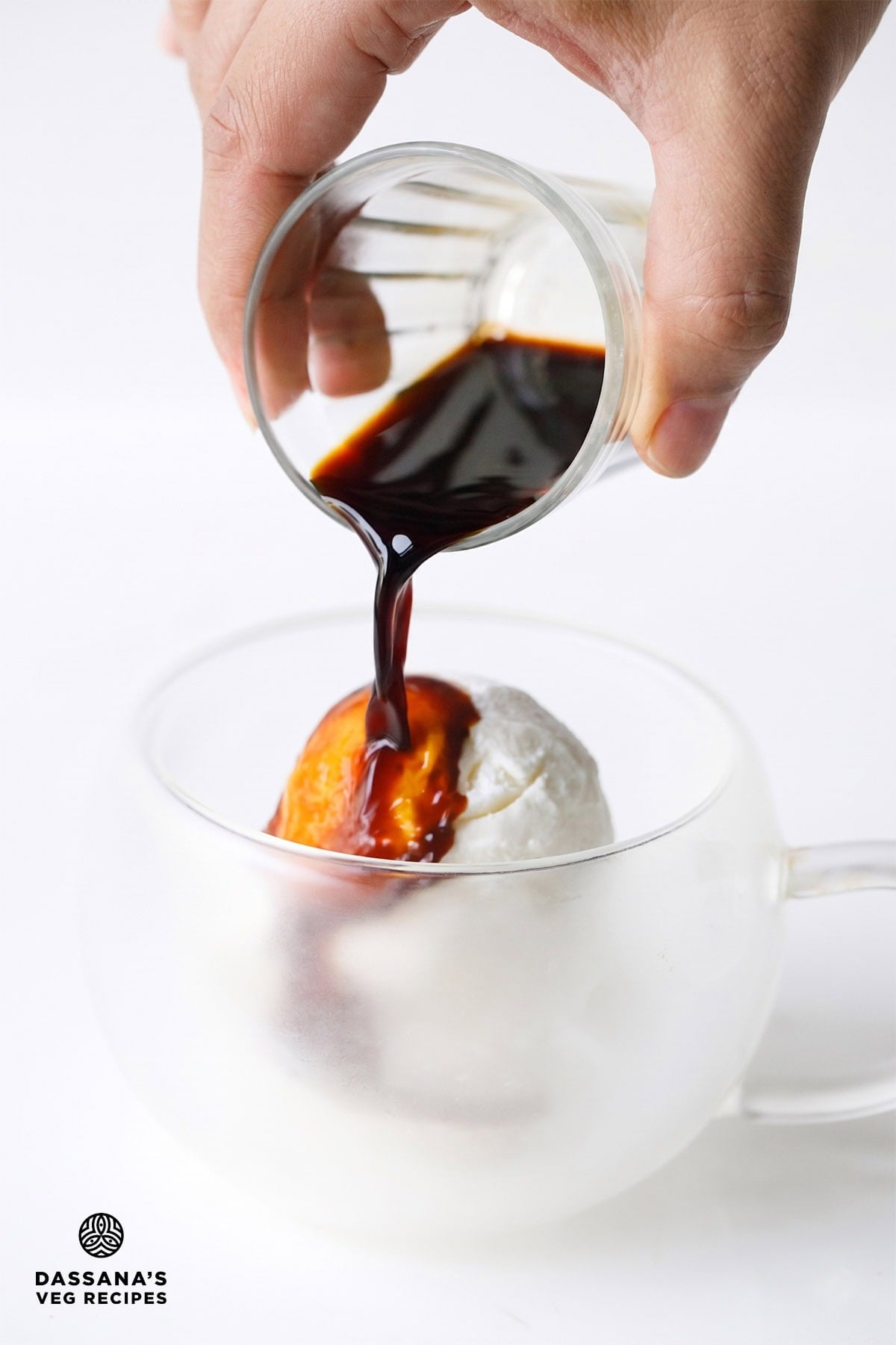 Espresso being poured over vanilla ice cream to make affogato.