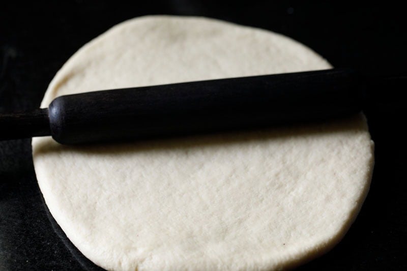 rolling the deep dish pizza crust dough.