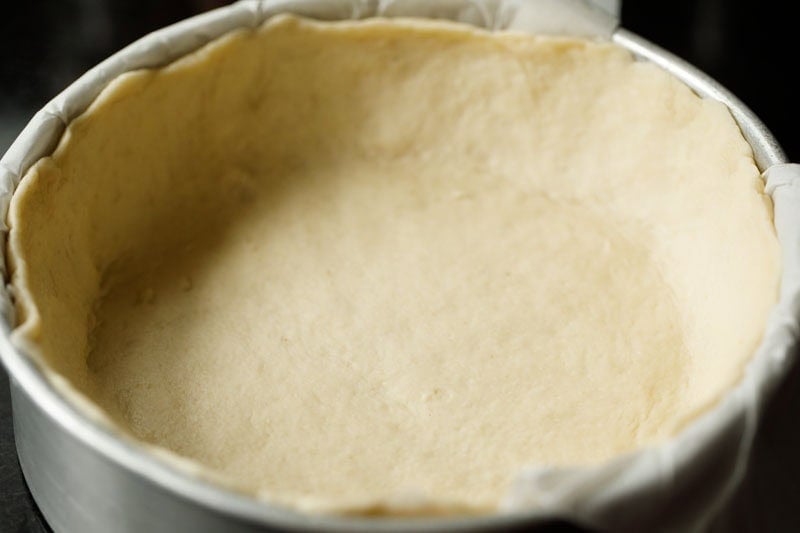 proofed deep dish pizza dough on pan.