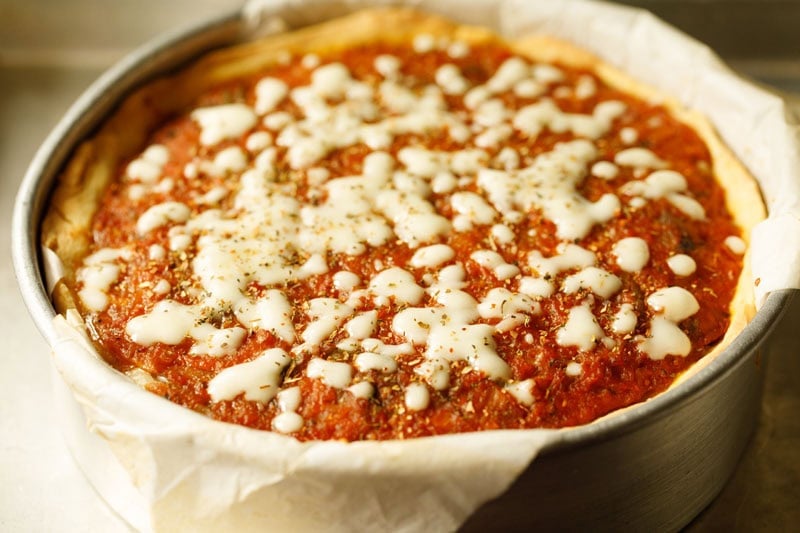 Deep dish pizza with melted cheese and sauce.