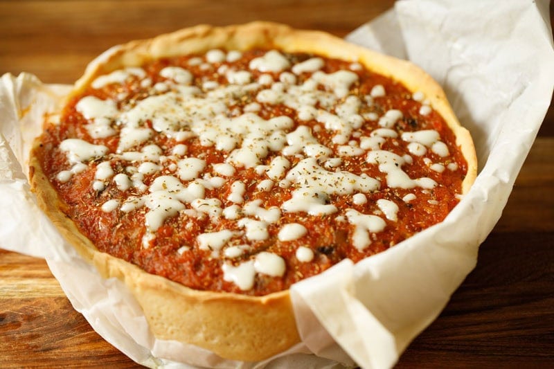 Cheesy Chicago deep dish pizza with sauce.