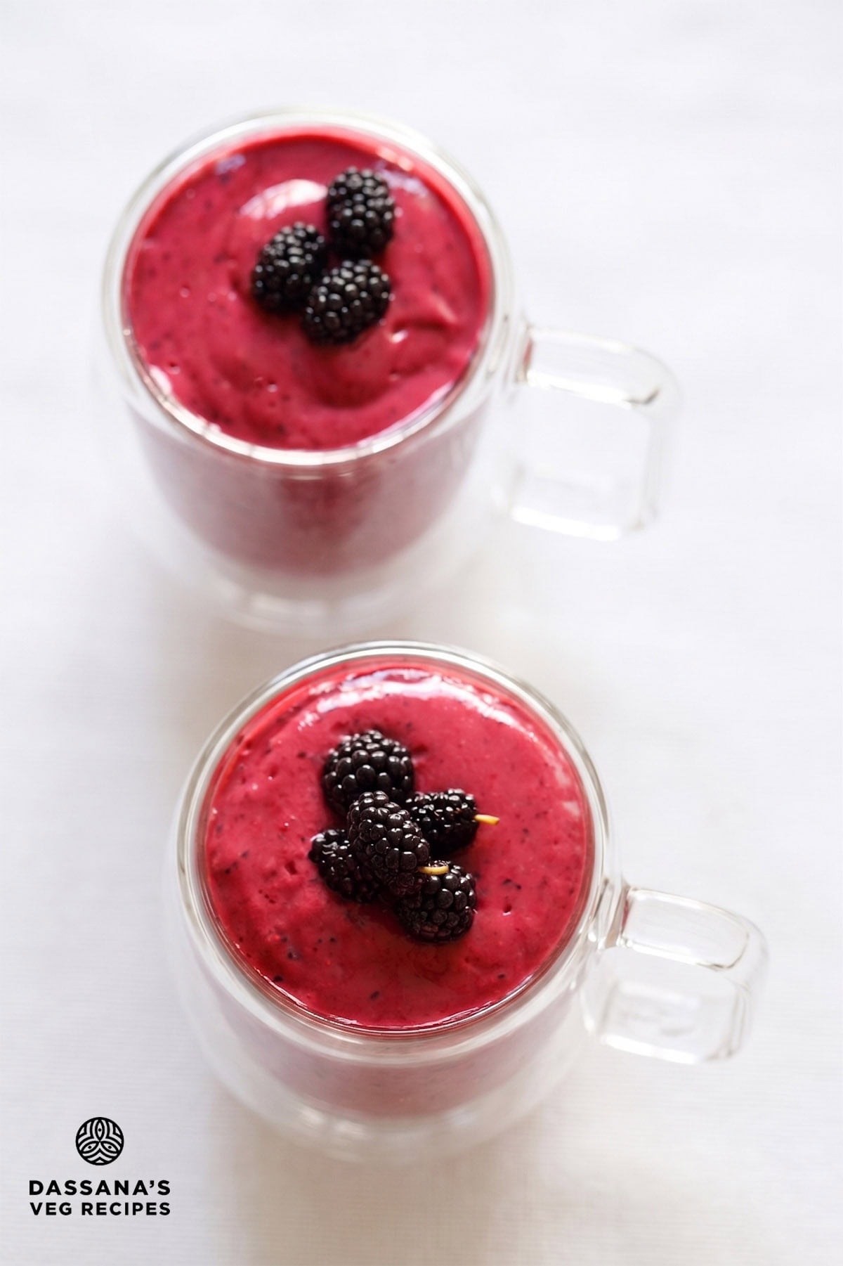 Overhead shot of berry blast smoothie drink in two glasses.