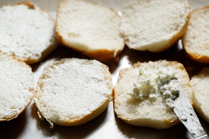 Sliced buns with white butter spread.
