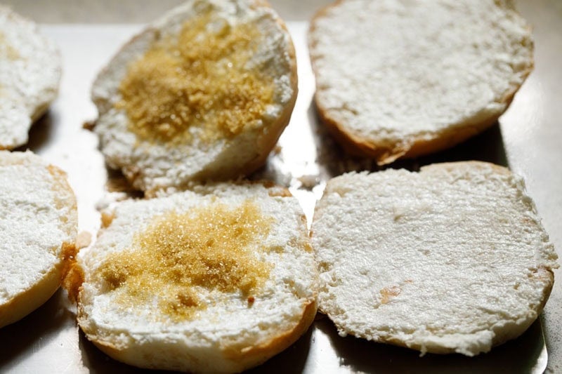 Sliced buttered buns with sugar topping.