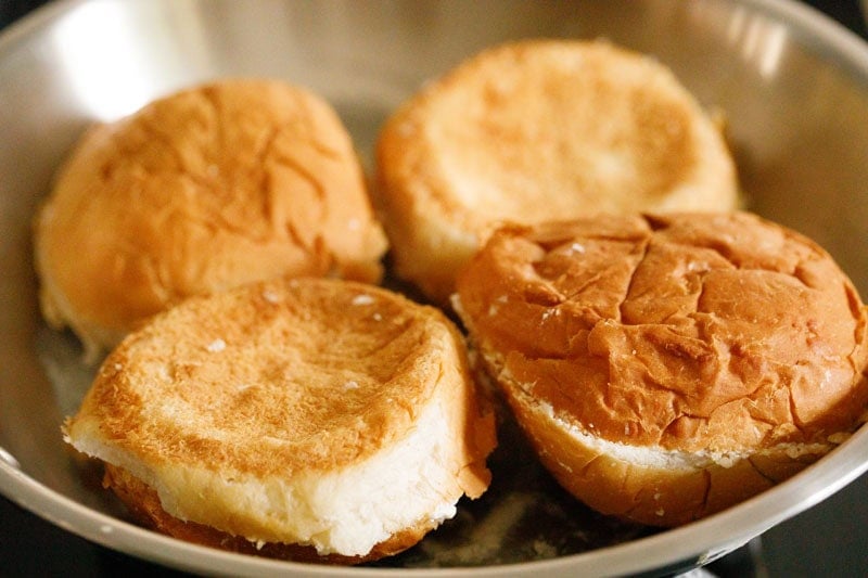 Buttered buns in frying pan.