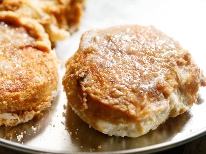 Golden butter bun spread with butter on top.