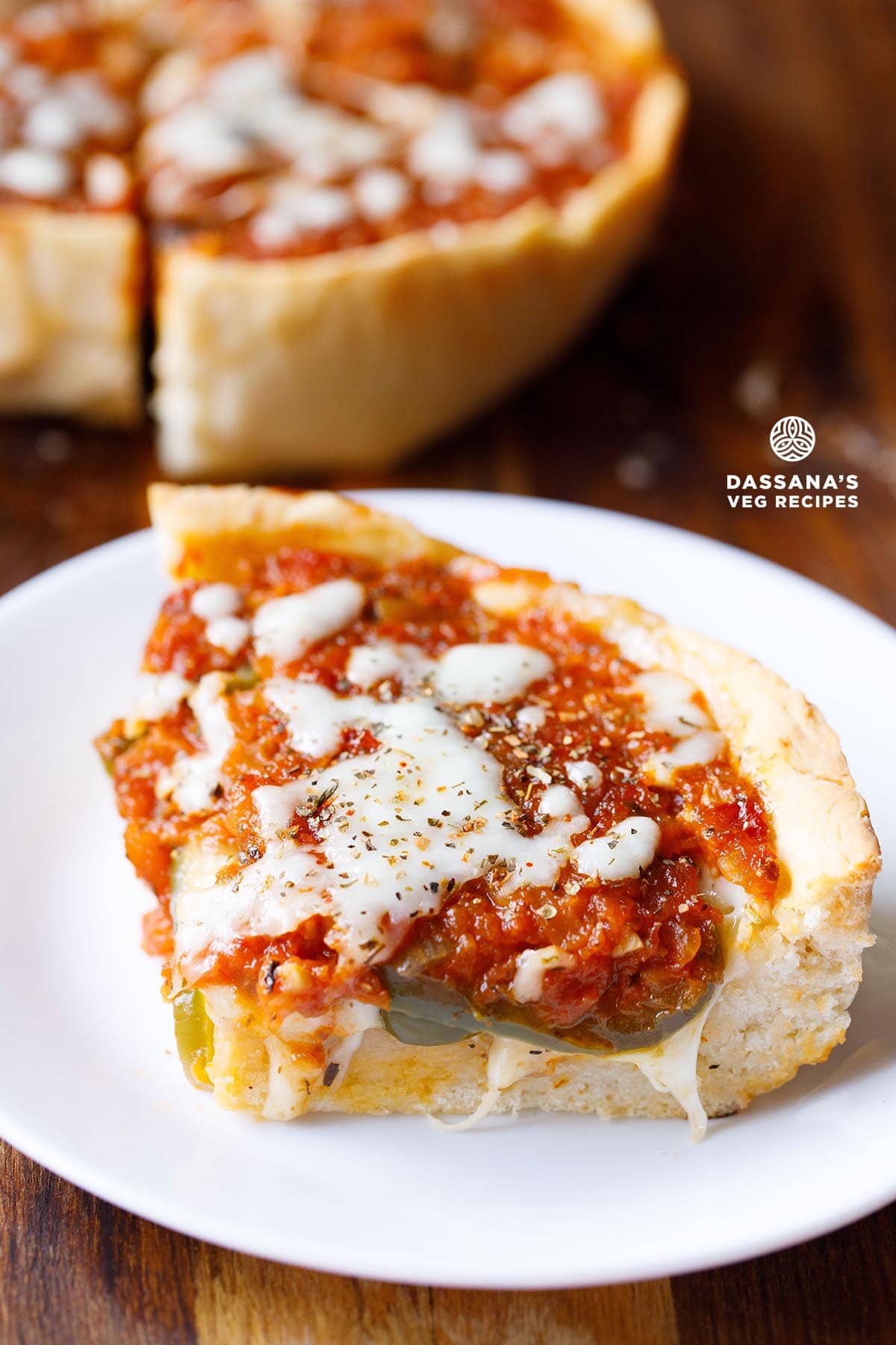 Slice of cheesy deep dish pizza.
