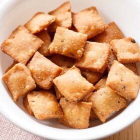 Diamond biscuit also known as diamond cuts or khara biscuit in a white bowl.