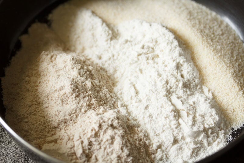 Whole wheat flour, all purpose flour (maida) and rava (semolina) in a mixing bowl.