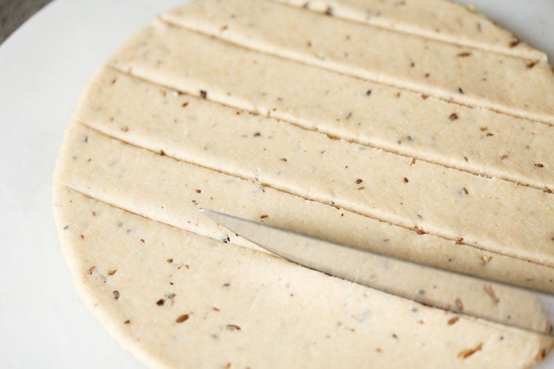 Rolled dough being cut.