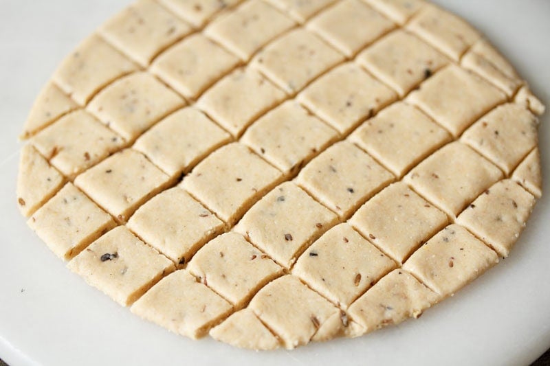 Cut dough into small square pieces.