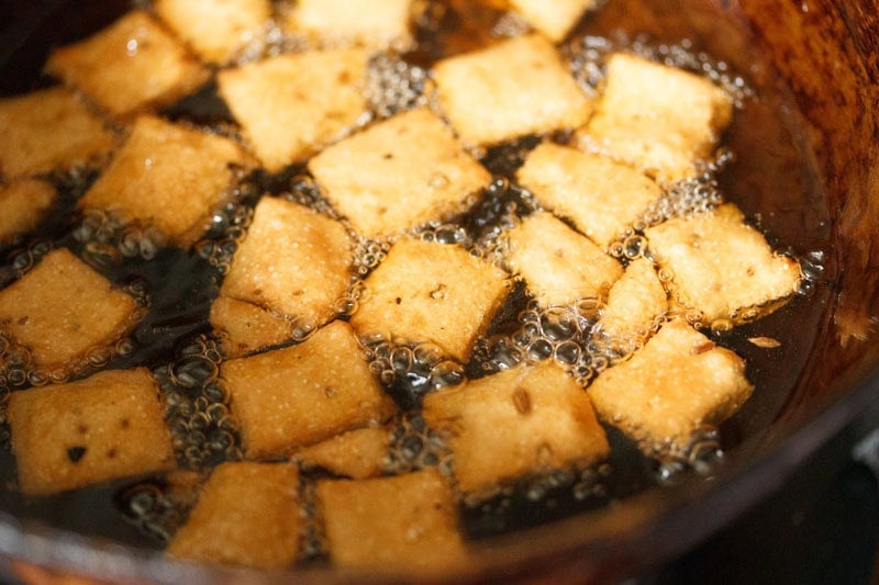 Khara biscuits frying in hot oil.