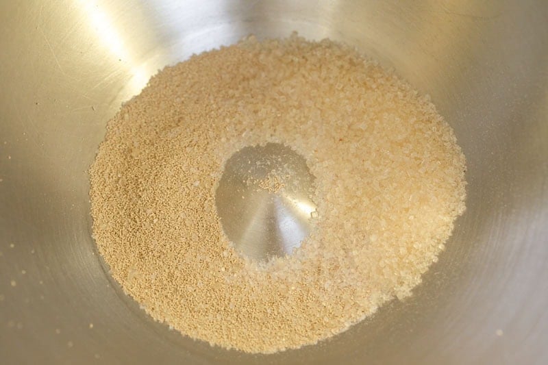 Bowl with granulated yeast and sugar.