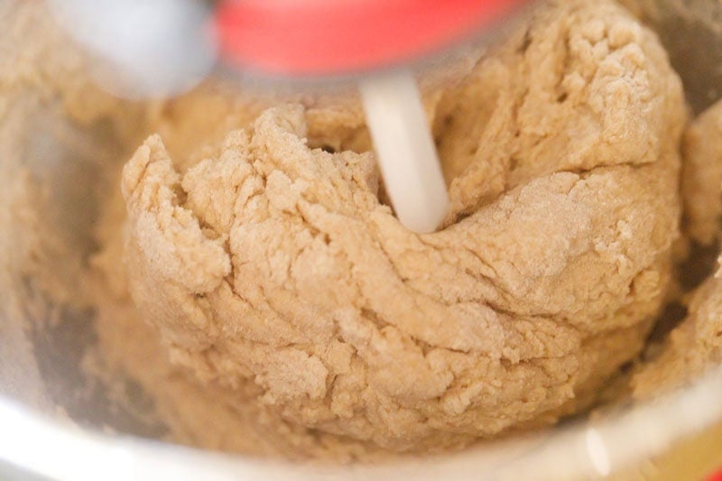 Mixing dough in a stand mixer bowl.