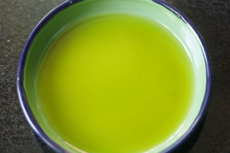 Olive oil in a small green bowl.
