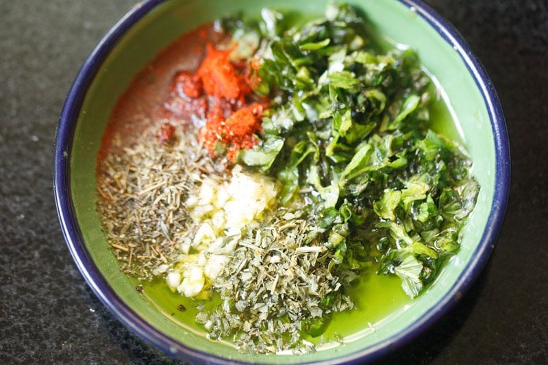 Herbs, olive oil and spices in a bowl.