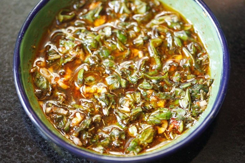 Herb-infused oil in a bowl.