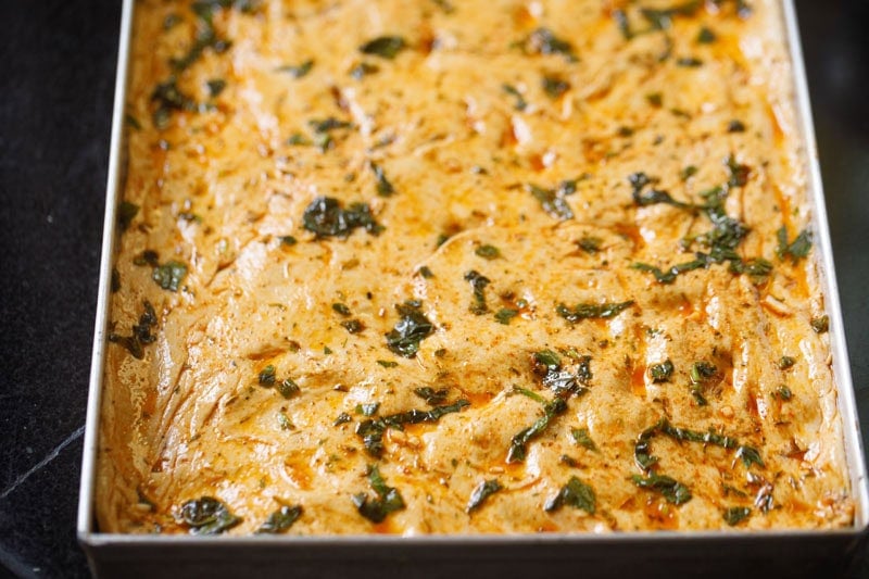 Herb-infused, golden-brown focaccia dough.